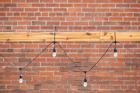 Electric Bulbs with wire on Red Brick Wall Background