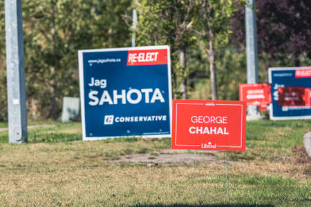 7 September 2021 - Calgary, alberta Canada - Candidate campaign signs on road for Federal electionsのeditorial素材