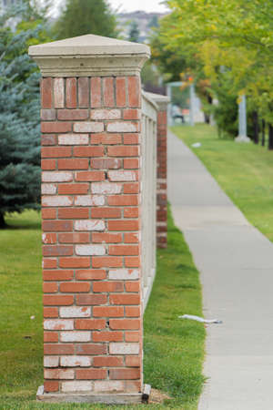 Fence beside a pavement on a city streetの写真素材