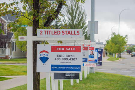 11 September 2020 - Calgary Alberta Canada - Real estate for sale signs on a streetのeditorial素材