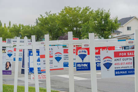 11 September 2020 - Calgary Alberta Canada - Real estate for sale signs on a streetのeditorial素材