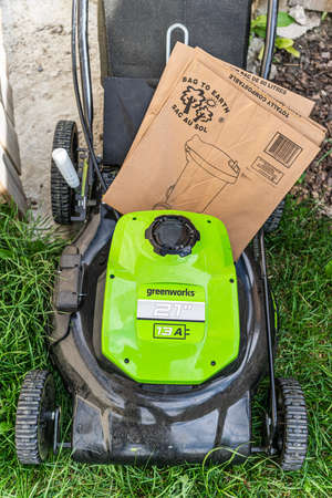 August 03 2020 - Calgary Alberta Canada - Electric Lawnmower with compost bagのeditorial素材