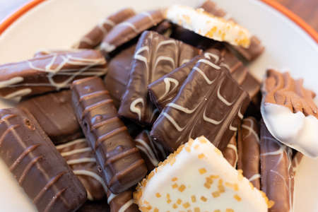 Collection of chocolate cookies and candies in a bowl