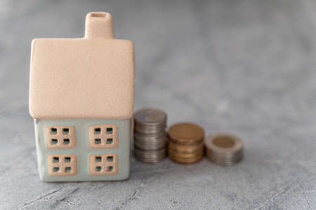 Model House with stack of coins - House financing mortgage conceptの写真素材