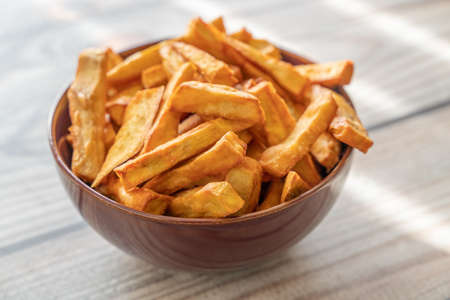 A bowl of Deep fried sweet potato fries in a bowlの写真素材