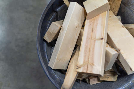 Waste pieces of wood from making crates in bin for disposalの写真素材