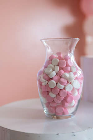 Pink and white sweets in a jarの写真素材