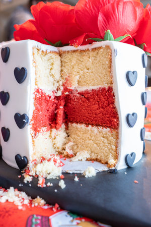 Birthday cake with slice taken out at party