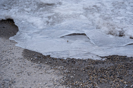Sheet of Cracked ice covering a parking lot in winterの写真素材