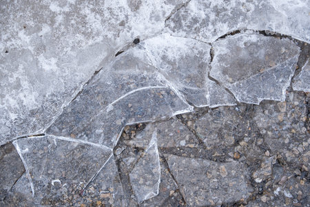 Sheet of Cracked ice covering a parking lot in winterの写真素材