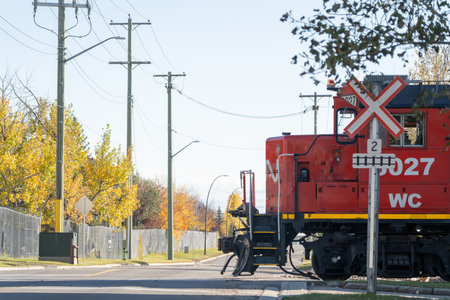1 October 2023 - Calgary Alberta Canada - CR Locomotive Crossing a roadのeditorial素材