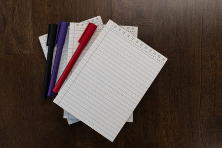 Paper writing blocks with colored pens