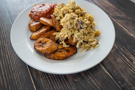 Plantain and Eggs with pepper tomato sauce ready to eatの写真素材