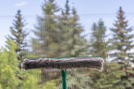 Dirty window is cleaned with window microfiber cloth
