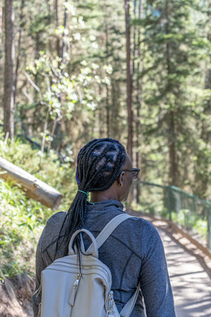 African American Nigerian woman walking in the forestの写真素材