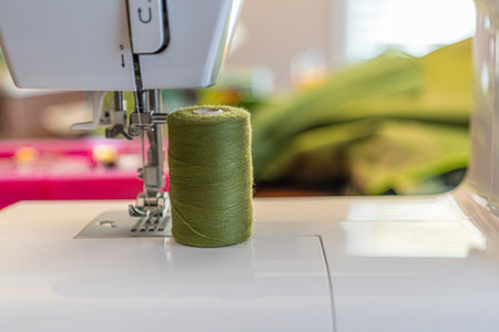 Electric sewing machine needle with spools of thread