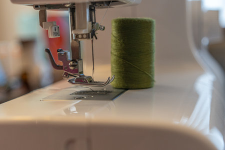 Electric sewing machine needle with spools of thread