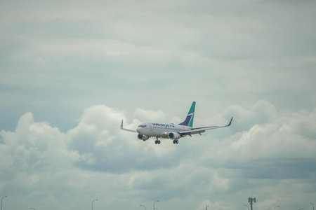 April 28 2024 - Calgary Alberta Canada - Westjet airliner landing on arrivalのeditorial素材
