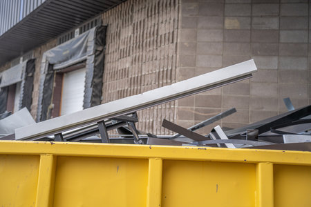 scrap metal steel in yellow recycle container