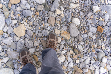 Man with hiking boots walking over rough groundの写真素材