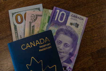 New Canadian Passport with Canadian and US Dollars bank notesの写真素材