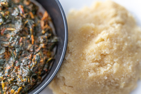 Nigerian Spicy vegetable soup and Eba fufu ready to eatの写真素材