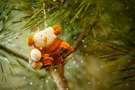 Toy Snowman In The Warm Clothing on The Christmas Treeの写真素材