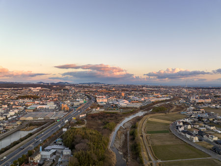 Akashi, Japan - January 30, 2023: Light traffic on highway and roads at edge of sprawling town at sunsetのeditorial素材
