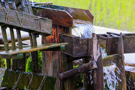 Ancient wood irrigation conveyor transports flowing water to rice fields