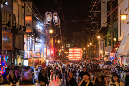 Kishiwada, Japan - September 17, 2023: Crowded street at lantern festival on rainy nightのeditorial素材