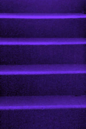 Stairs with blue carpet leading to the top.の写真素材