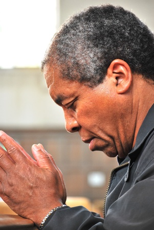 African american male praying in church.の写真素材