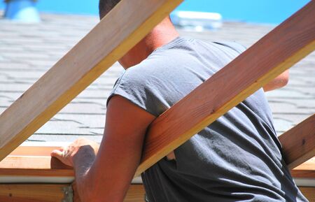 Carpenter building a new patio deck addition 