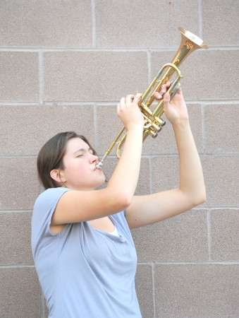 Female trumpet player blowing her horn.の写真素材