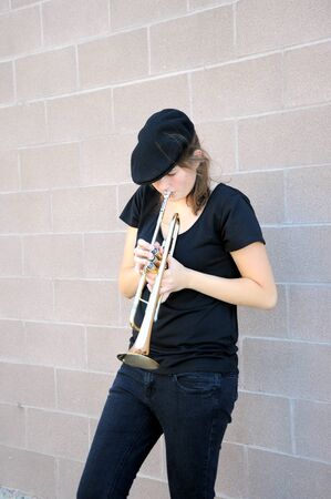 Female trumpet player blowing her horn.
