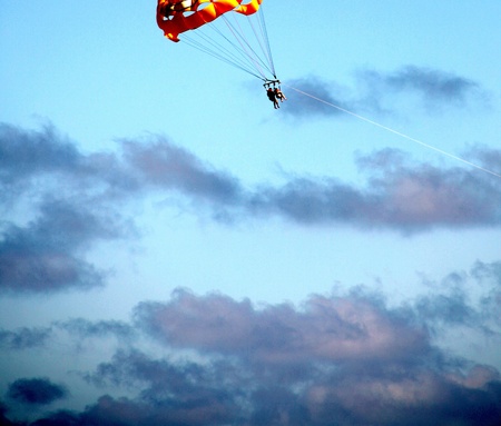 Couple parasailing high in the sky.の写真素材