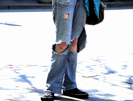 Grunge homeless female begging for food on the street.の写真素材