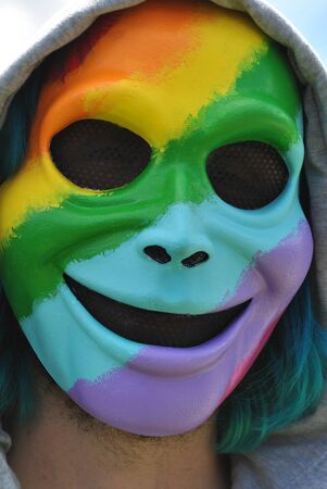 Gay Pride rainbow face masked displayed outdoors.の写真素材