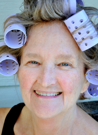 Female beauty wearing hair rollers.の写真素材