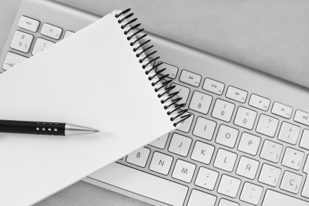 Notebook, pen and computer keyboardの写真素材