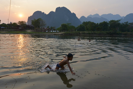 Vang Vieng, Laos  Unidentified children bathing in the river on March 3, 2014 in Vang Vieng  Laos のeditorial素材