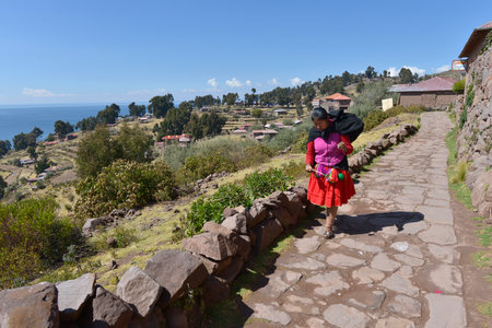 TAQUILE ISLAND, LAKE TITICACA, PERU - SEPTEMBER 6: A woman waering to traditional cloth on September 6.2015 in Taquile island, Titicaca lake, Peru.のeditorial素材