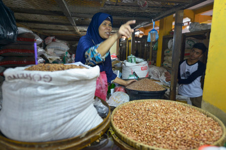 Yogyakarta, Java, Indonesia - August 6: Unidentified woman selling vegetables at a market Yogyakarta on August 6, 2016 in Yogyakarta, Java, Indonesiaのeditorial素材