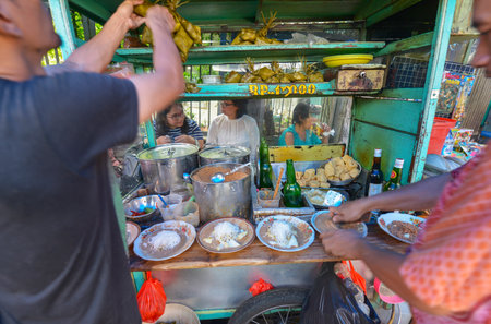 Jakarta, Java, Indonesia - August 25: People eating at a street food stall on August 25, 2016 in Jakarta, Java, Indonesia.のeditorial素材
