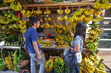 Jakarta, Java, Indonesia - August 25: A man selling bananas at a Jakarta market on August 25, 2016 in Java, Indonesiaのeditorial素材