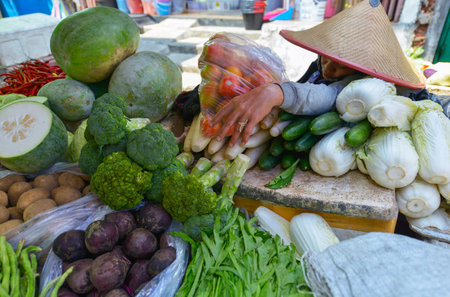 Jakarta, Java, Indonesia - August 25: An unidentified woman selling food at a Jakarta market on August 25, 2016 in Java, Indonesiaのeditorial素材