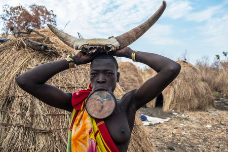 Omorate, Ethiopia - January 24: Unidentified woman of the Mursi tribe with traditional jewelry with...