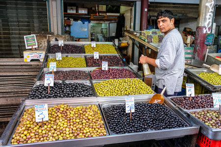 Athens, Greece - December 29: An unidentified man selling olives in the central market of Athens on December 29, 2017 in Athens, Greece.のeditorial素材