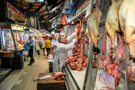 Athens, Greece - December 29: A butcher preparing meats for a customer in Central Market on December 29, 2017 in Athens, Greece.のeditorial素材