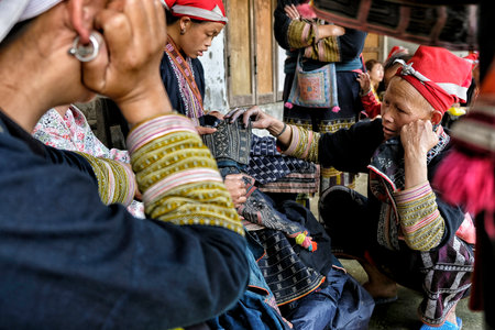 Ta Phin, Vietnam - August 24: Red Dao women sewing in the village on August 24, 2018 in Ta Phin. Red...